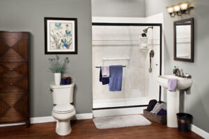 a newly installed shower with new surround, glass doors, and shelving