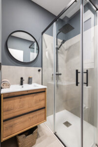 Modern bathroom with a large walk-in shower with glass doors.