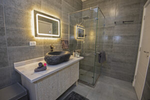Luxurious bathroom with a modern vanity and walk-in shower.