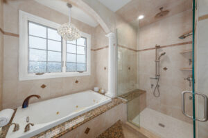 Large bathroom recently remodeled to include a walk-in shower and large bathtub.